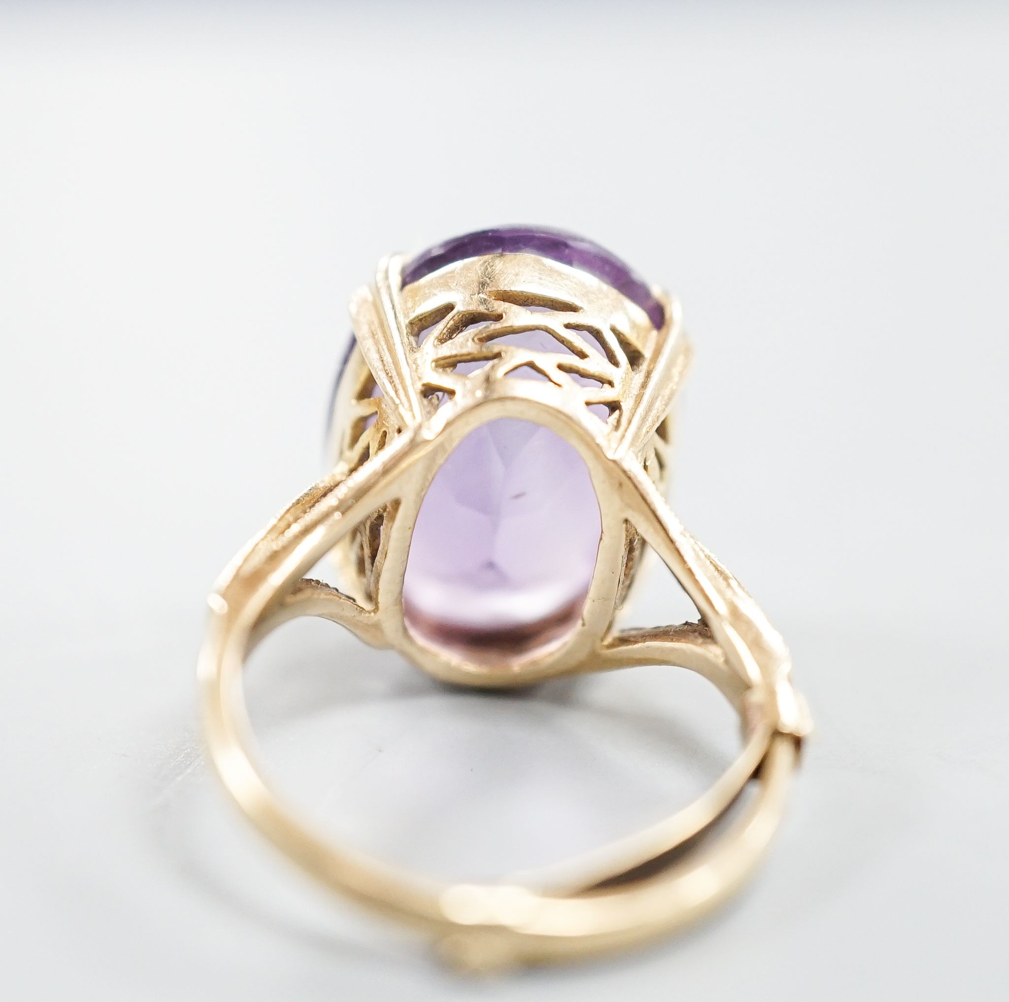 A modern 9ct gold and oval cut amethyst set dress ring, size L/M, gross weight 5.7 grams.
